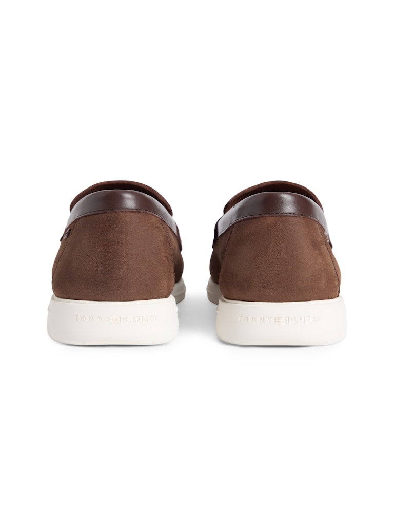 Heel view of brown leather loafers with white sole and small Tommy Hilfiger logo
