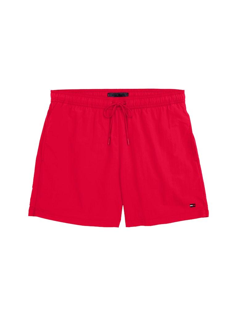 Bright red swim shorts with an elastic waistband and drawstring and small Tommy Hilfiger logo, shown flat against a plain white background.