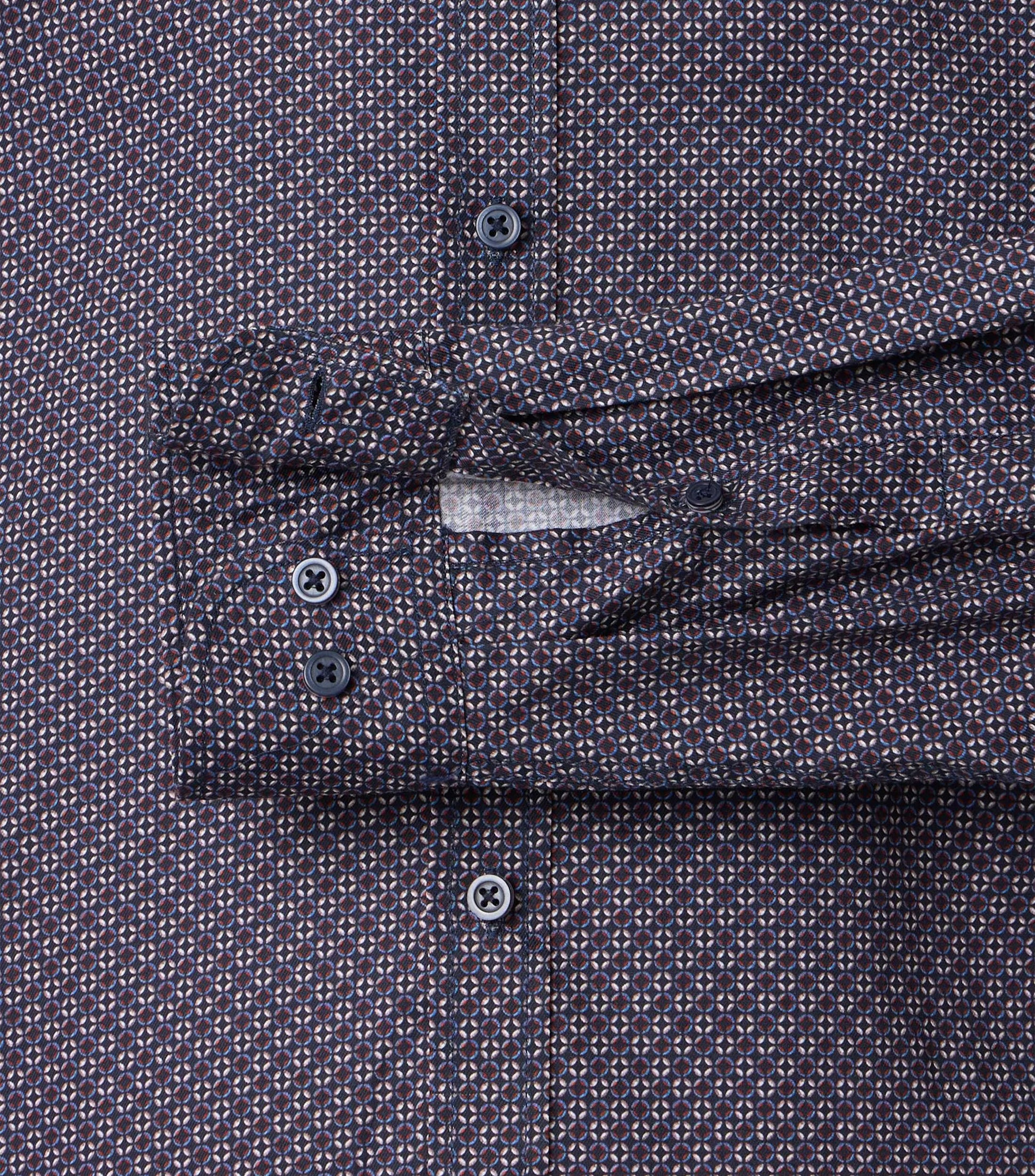 Close-up of a patterned shirt with sleeve cuff and buttons.