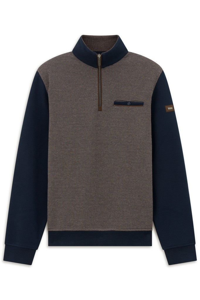A men's colorblock quarter-zip pullover sweater with a heathered brown body, navy blue collar, sleeves, and hem, featuring a chest pocket with a snap tab and a small brown sleeve patch.