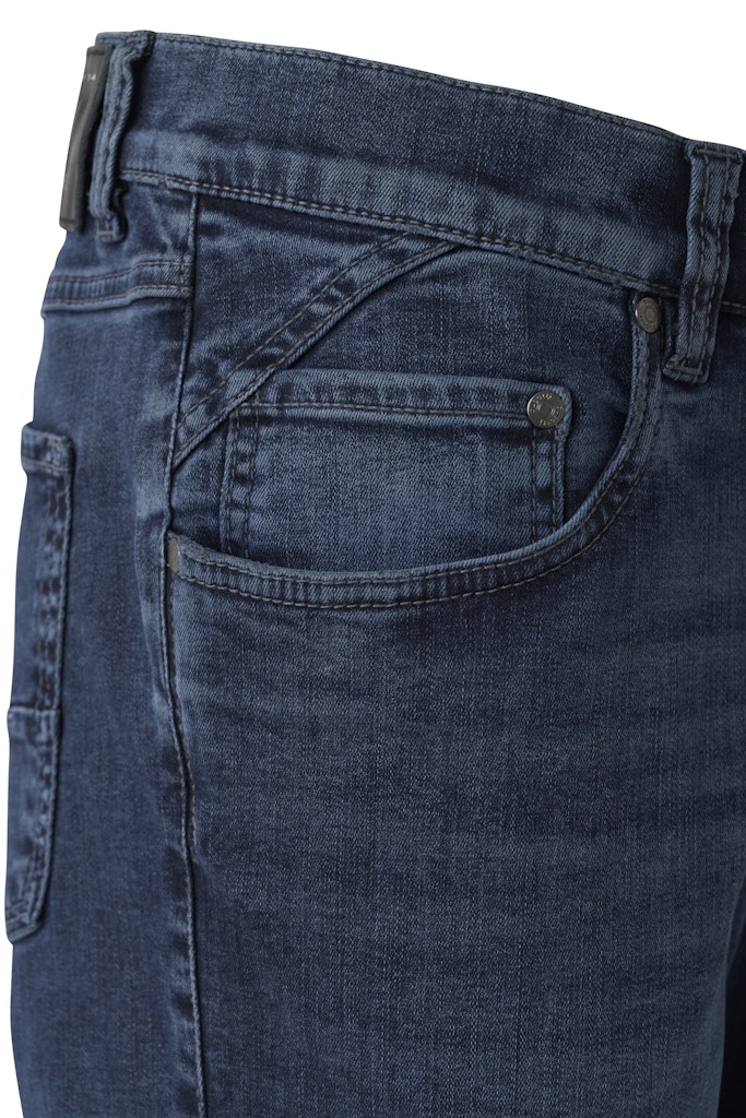 Close-up of the waistband and right pocket of dark blue denim jeans, showing stitching, belt loops, and a metal button.