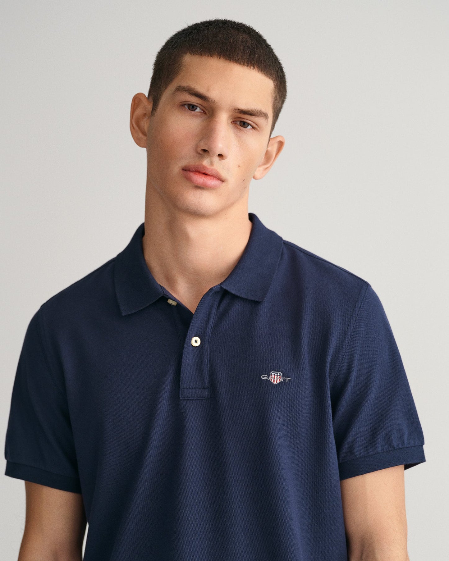 GANT Regular Shield Pique Polo on model, front close up, evening blue - Matt O'Brien Fashions